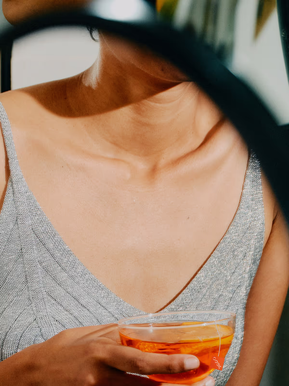 A glass of tea held close